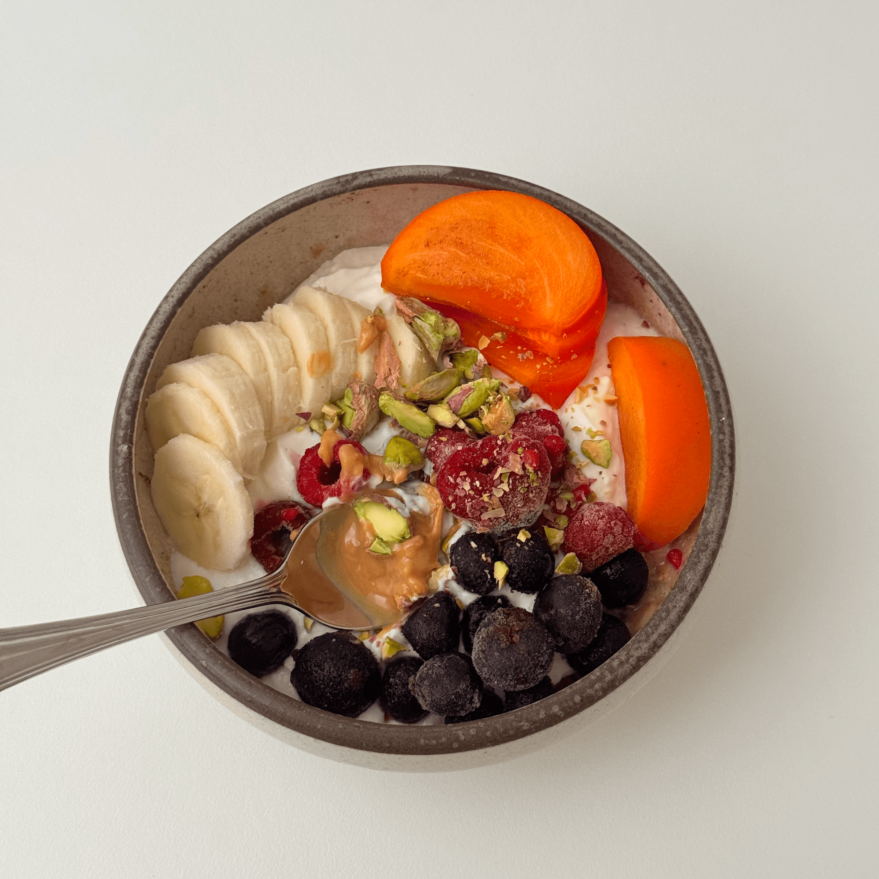 A loaded greek yogurt bowl with colorful toppings